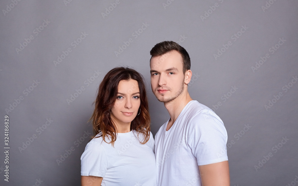 Fototapeta premium A beautiful young couple in white T-shirts.