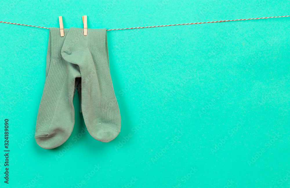 colorful socks hanging on a rope on pastel background - Image colorful socks hanging on a rope on pastel background - Image