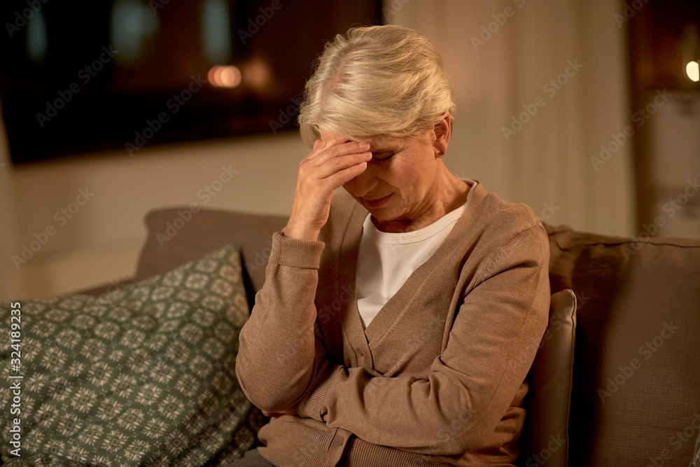 © Syda Productions - pain, stress and people concept - unhappy senior woman suffering from headache at home at night