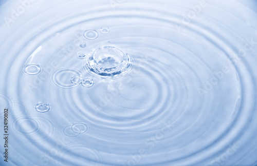 Water drop and wave splash in white ceramic bowl