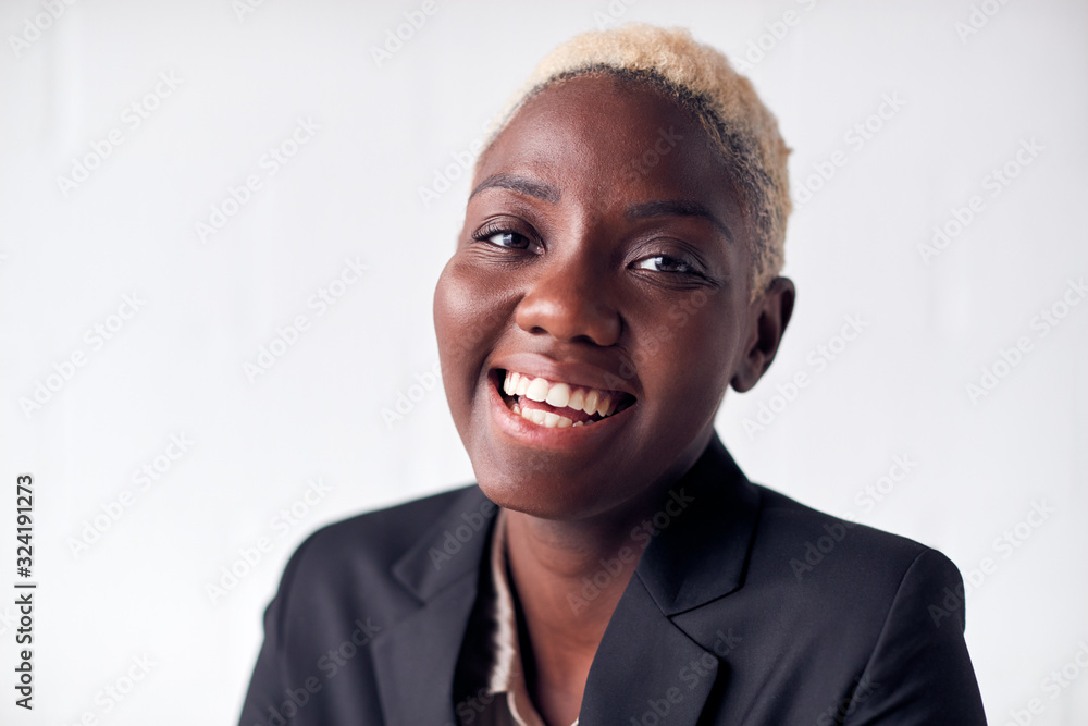 © Monkey Business - Portrait Of Smiling Young Businesswoman Wearing Suit Standing Against White Studio Wall © Monkey Business - Portrait Of Smiling Young Businesswoman Wearing Suit Standing Against White Studio Wall