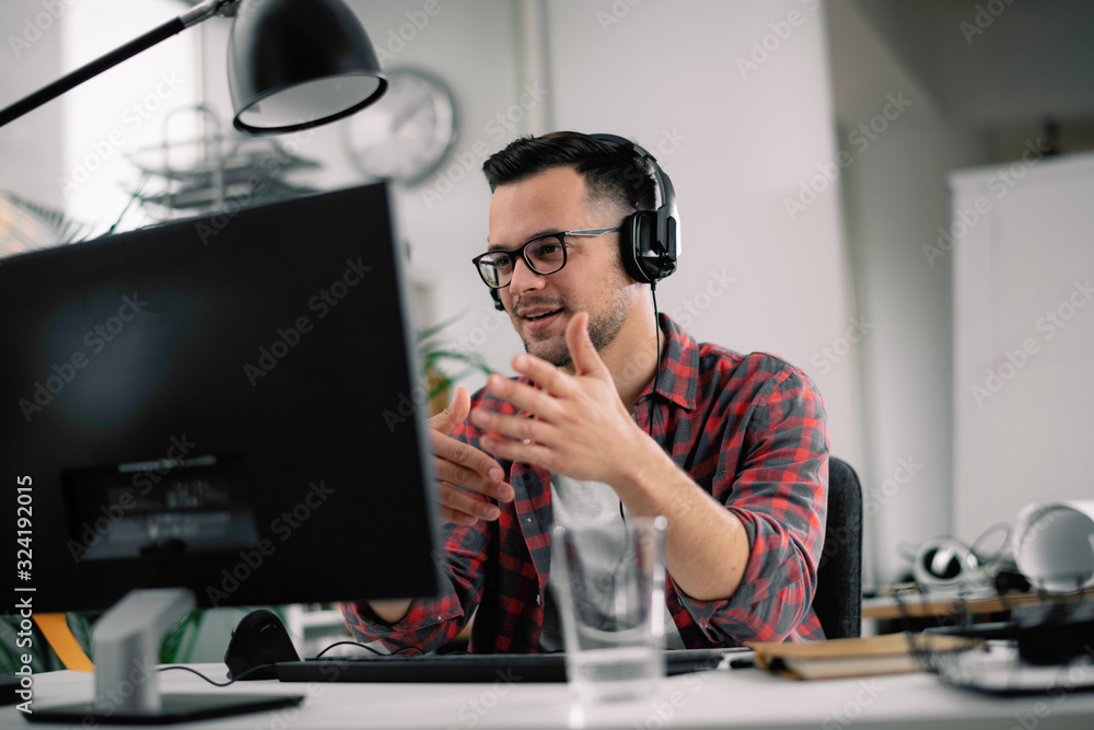 Businessman on video call. Handsome man in office with headphones. 