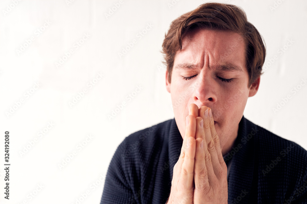 Studio Shot Of Unhappy Man Putting Hands To Face Studio Shot Of Unhappy Man Putting Hands To Face
