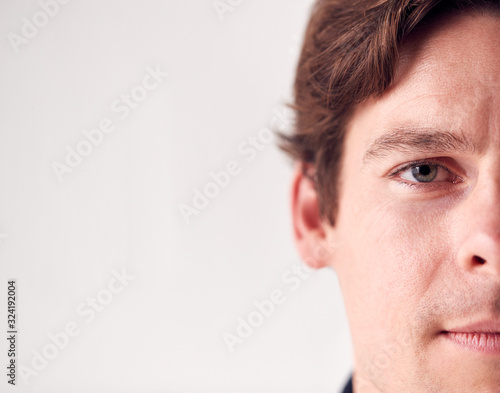 Close Up Portrait Man With Slight Smile Standing In Studio