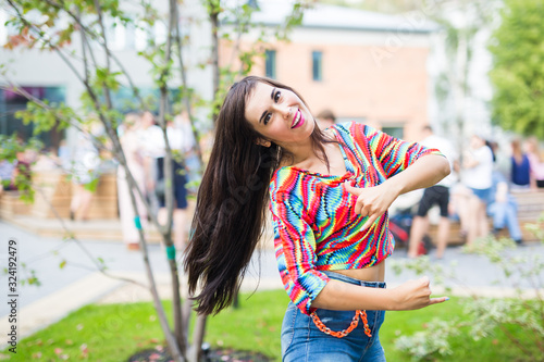 Street shaabi dance and urban dancer concept - Cheerful belly dancer dancing with arabic music on the street photo