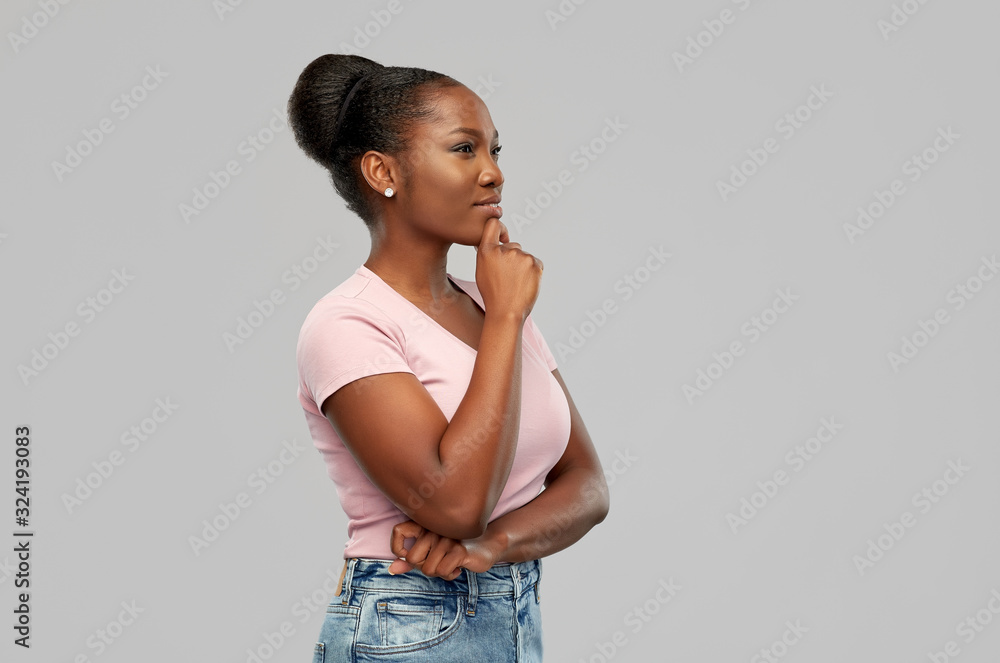 people, inspiration and dream concept - happy african american young woman thinking over grey background people, inspiration and dream concept - happy african american young woman thinking over grey background