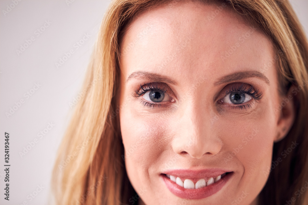 Close Up On Face Of Smiling Young Woman In Studio Close Up On Face Of Smiling Young Woman In Studio