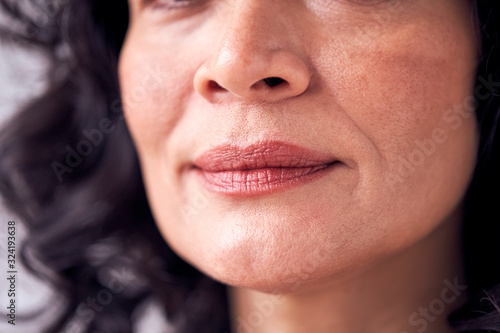 Close Up On Mouth Of Smiling Mature Woman In Studio