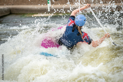 GB Canoe Slalom Athlete in C1W class in white water action. Paddling away and surrounded by splashes