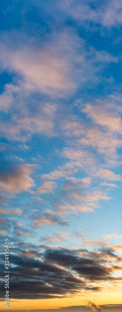 Fantastic clouds at sunrise, vertical panorama