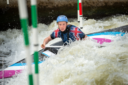 Obraz na plátne Close up action of a GB Canoe Slalom Athlete negotiating the poles of slalom gat