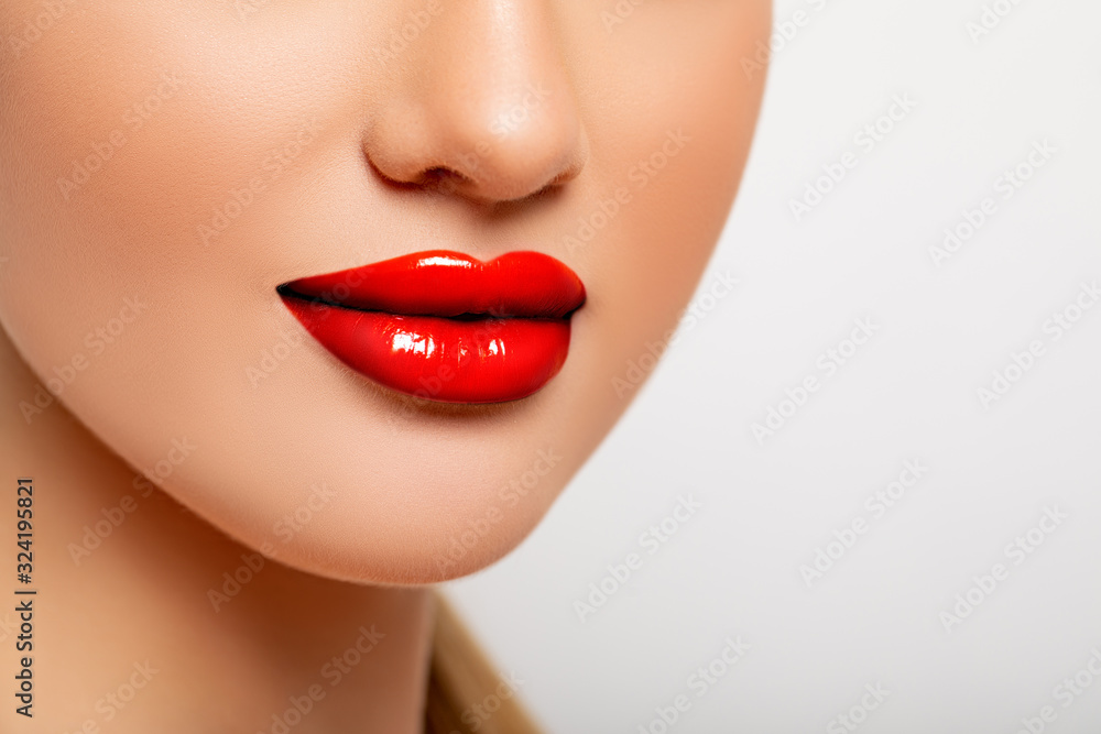 Fototapeta premium Sexy Red Lips closeup. Beauty Lips with Red Lipstick. Perfect Makeup. Young Woman close up. 