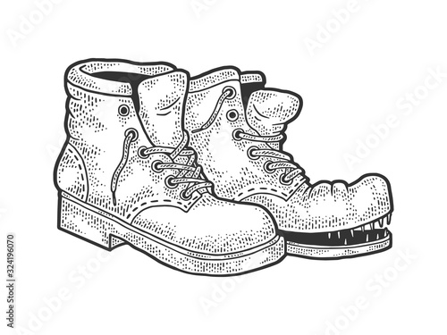 Old shabby ragged torn boots sketch engraving vector illustration. T-shirt apparel print design. Scratch board imitation. Black and white hand drawn image.