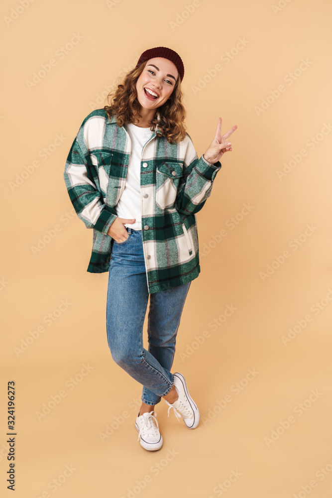 Photo of pretty joyful woman laughing and gesturing peace sign Photo of pretty joyful woman laughing and gesturing peace sign