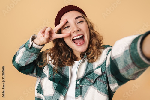 Canvas-taulu Photo of pretty happy woman taking selfie and gesturing peace signa