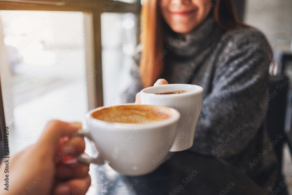 © Farknot Architect - Closeup image of a woman and a man clinking coffee mugs in cafe © Farknot Architect - Closeup image of a woman and a man clinking coffee mugs in cafe