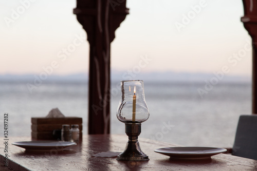 View of the Red sea from a restautant with a table set up with candle