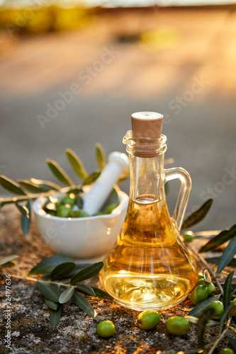 Olive oil and olive berries with leaves outdoor