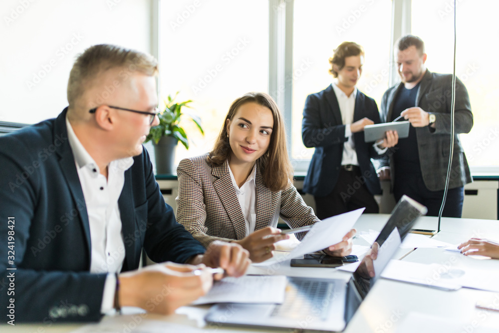 Colleagues talking at work in an informal meeting area. Business meeting Colleagues talking at work in an informal meeting area. Business meeting