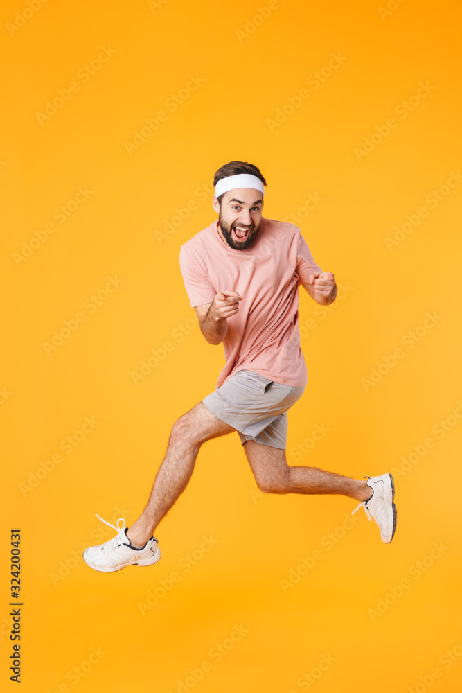 Image of muscular athletic young man having fun while doing workout