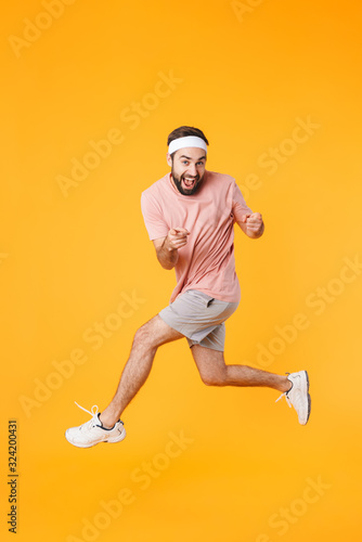 Image of muscular athletic young man having fun while doing workout