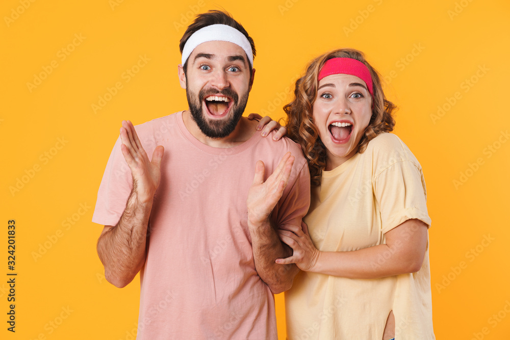 Portrait of athletic cheerful couple screaming together in surprise Portrait of athletic cheerful couple screaming together in surprise