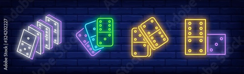 Stacks of domino tiles neon sign set. Play, game, activity. Vector illustration in neon style, bright banner for topics like strategy, entertainment, leisure, recreation