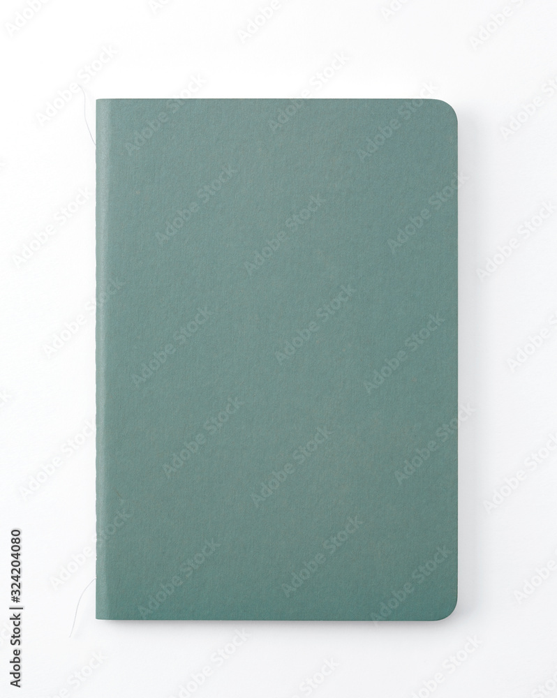 Top view of closed stitch blank recycled paper cover notebook on white background. Top view of closed stitch blank recycled paper cover notebook on white background.