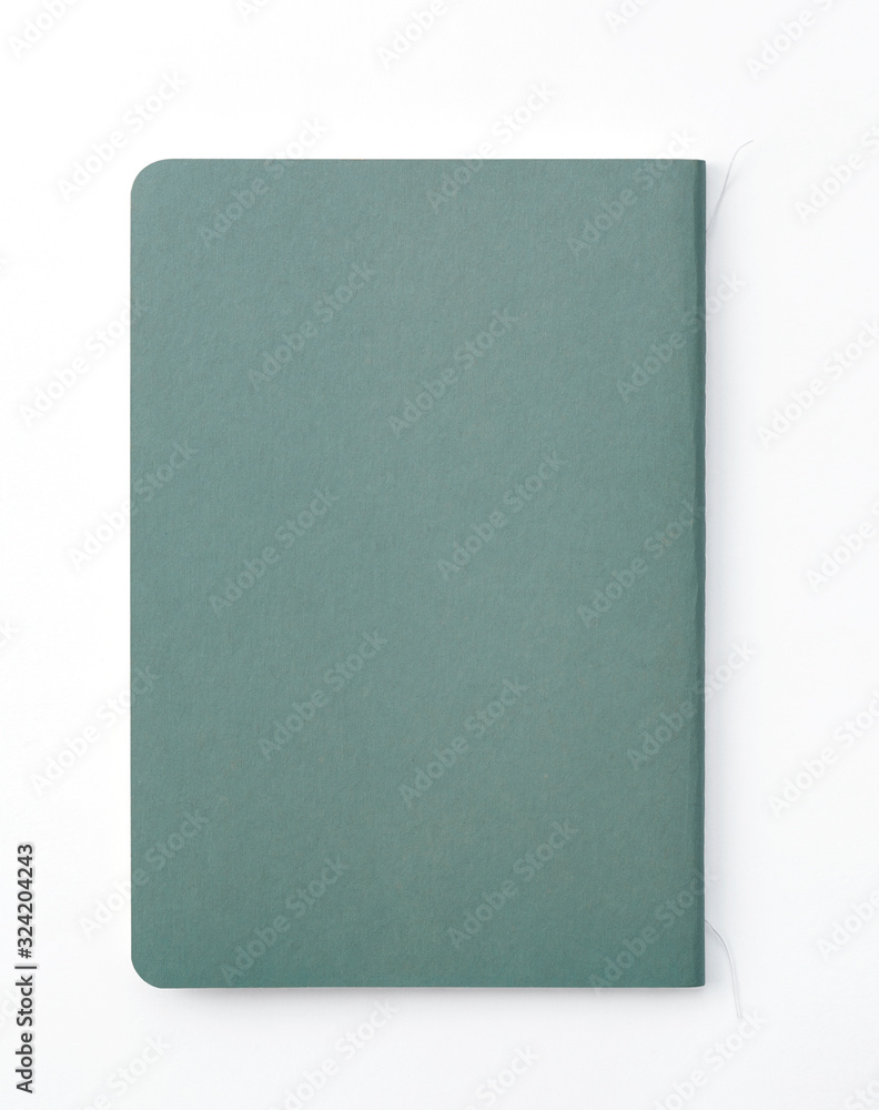 Top view of closed stitch blank recycled paper cover notebook on white background. Top view of closed stitch blank recycled paper cover notebook on white background.