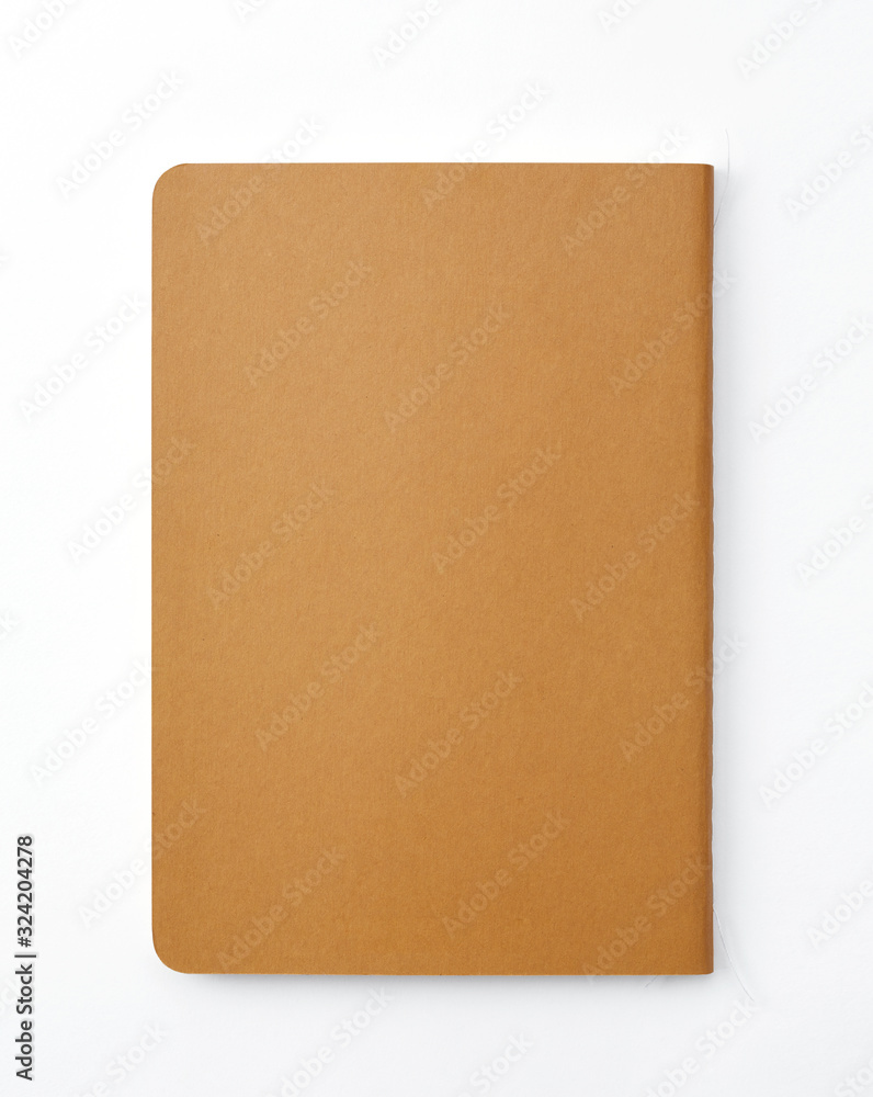 Top view of closed stitch blank recycled paper cover notebook on white background. Top view of closed stitch blank recycled paper cover notebook on white background.