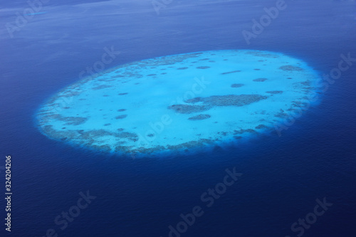 Aerial view of round Tila coral reef