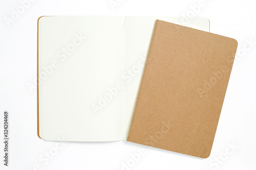 Top view of open stitch blank recycled paper cover notebook on white background.