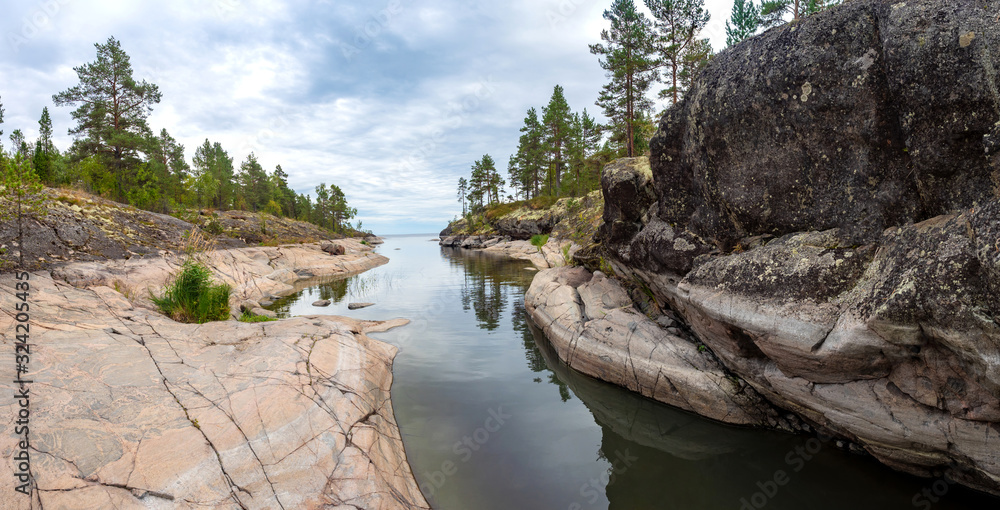 Russia. Panorama Of Karelia. Ladoga. Skerry. The river with rocky banks flows into lake Ladoga. Northern nature. Karelian landscape. Rocky shores with pine trees. Nature of Russia.