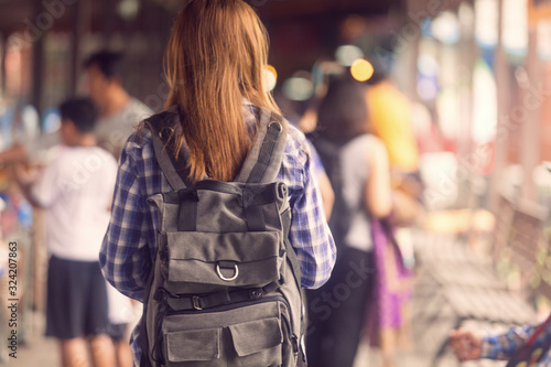 women backpack tourists travel in the market with a lot of people , tourism concep photo