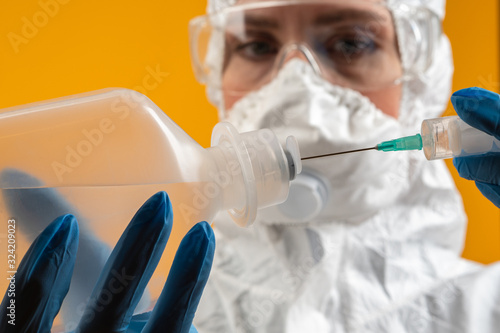 Coronavirus. 2019-nCoV. Development of licorice against the virus. Study of the Chinese virus. Lab technician takes a sample of the virus. Human takes a sample with a syringe. Protective suit