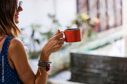 Woman enjoying coffee / tea at home.