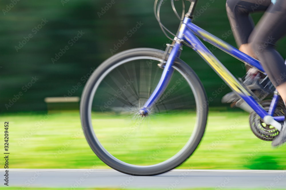 Fototapeta premium Riding bicycle - blurred motion, fast driving.