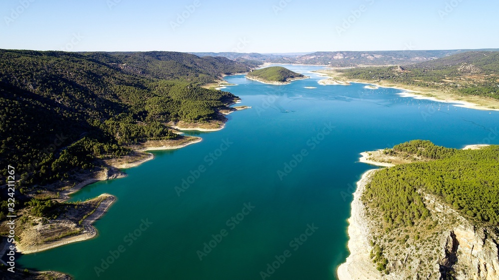 A beautiful scenery of green mountains and blue lake under the bright sky