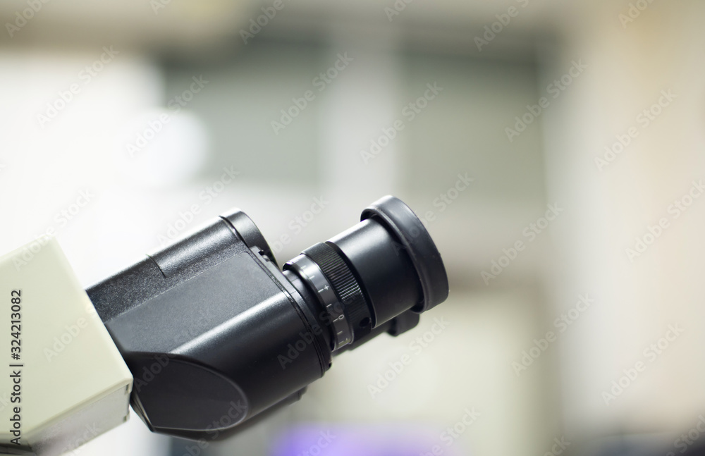 Microscope with metal lens at laboratory.