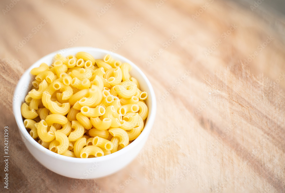 Raw macaroni in a bowl. Raw macaroni in a bowl.