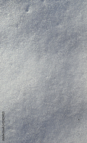 Sparkling snow texture - vertical winter background of snow on sunny frosty day