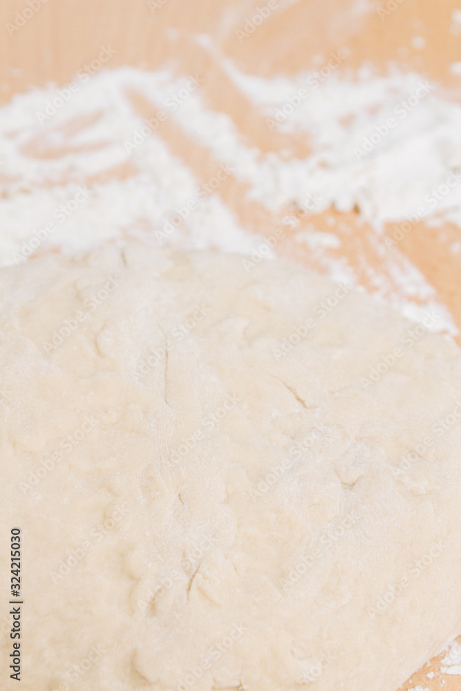 Prepared kneaded dough on a wooden table at home Prepared kneaded dough on a wooden table at home