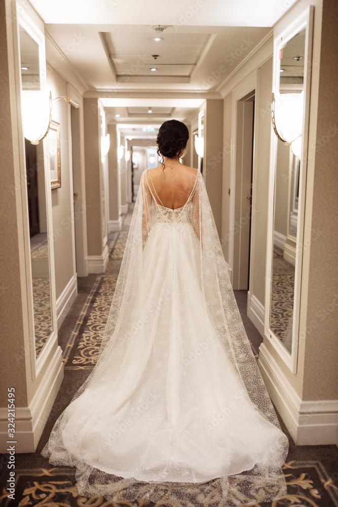 Portrait of beautiful bride with red bouquet in the hall Portrait of beautiful bride with red bouquet in the hall