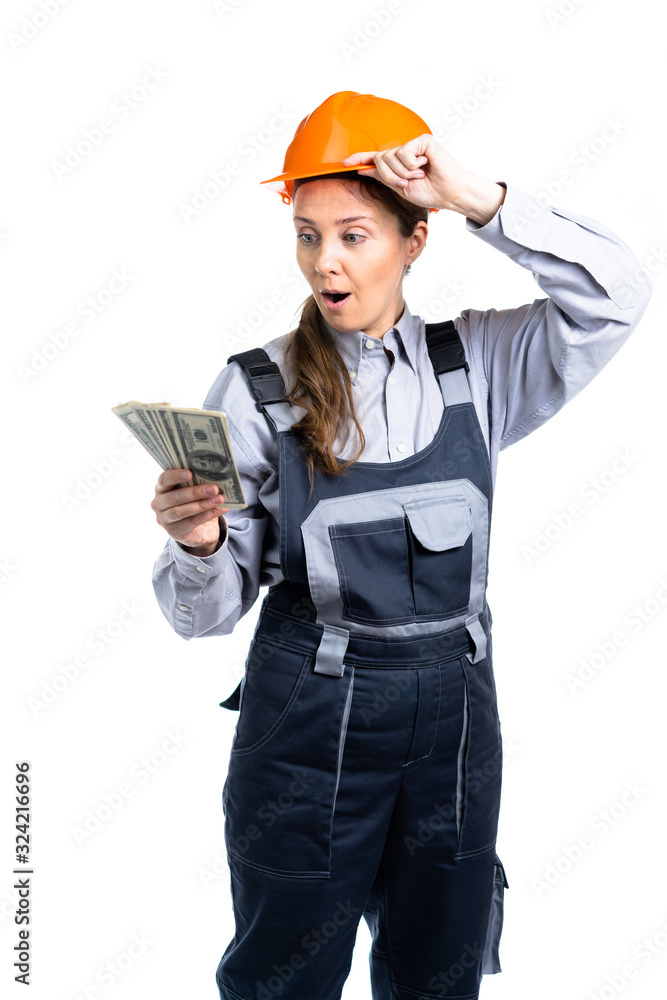 Builder engineer girl with money in her hand rejoices in so many dollars. Isolated Builder engineer girl with money in her hand rejoices in so many dollars. Isolated