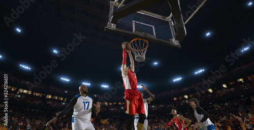 Basketball players on big professional arena during the game. Tense moment of the game. View from below the basket