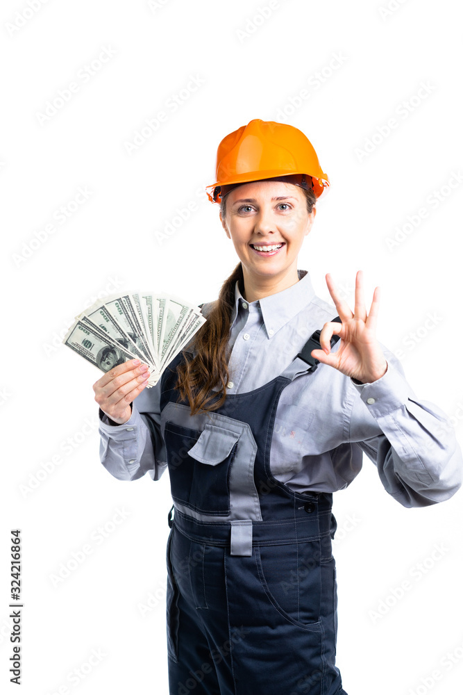 Builder engineer girl with money in hand is very happy with her finances. Isolated Builder engineer girl with money in hand is very happy with her finances. Isolated