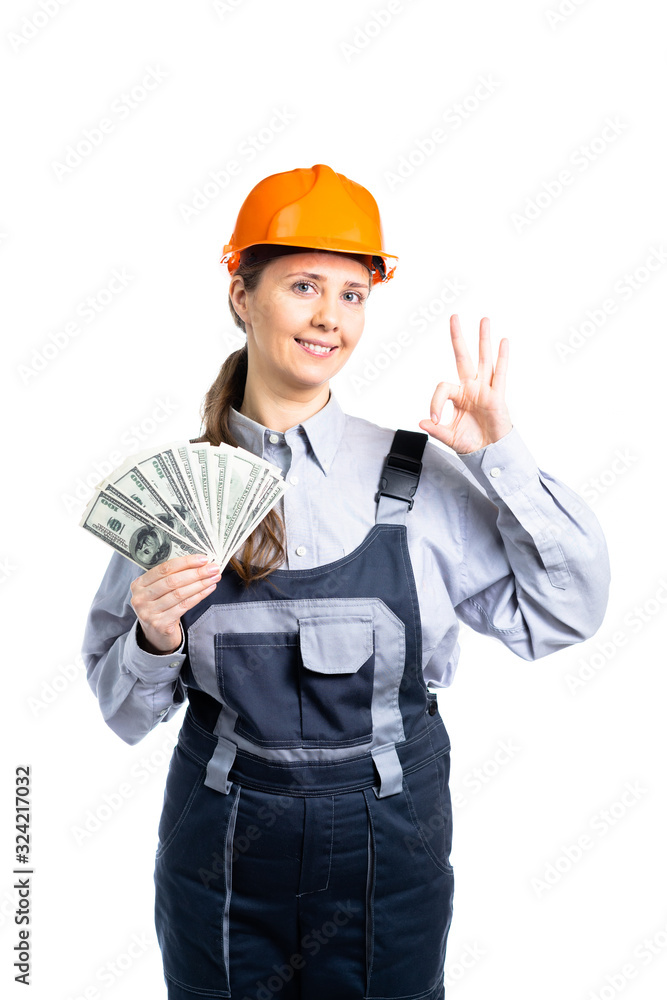 Builder engineer girl with money in hand is very happy with her finances. Isolated Builder engineer girl with money in hand is very happy with her finances. Isolated