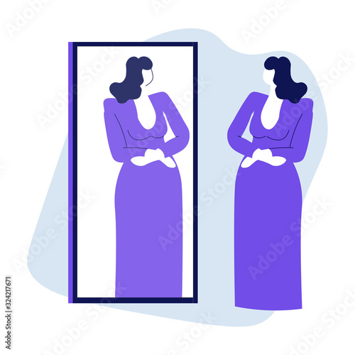 Woman looking at mirror reflection and trying on evening dress