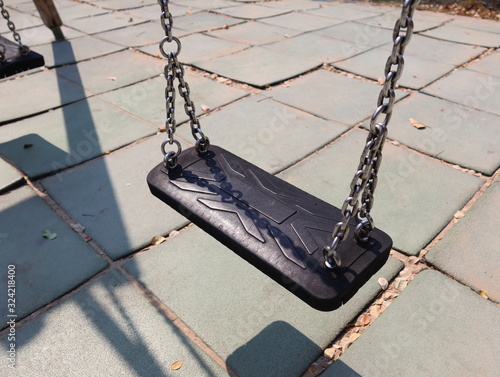 Empty chain swing in playground in city