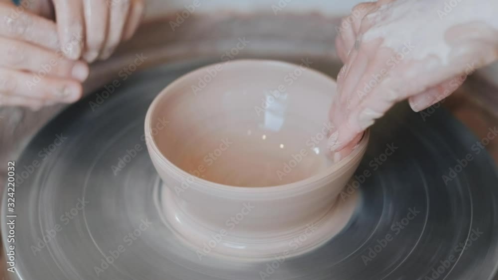 master teaching a little girl the art of pottery. close-up master teaching a little girl the art of pottery. close-up
